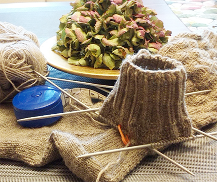 Bild gestricktes Bündchen mit Nadeln und Wolle